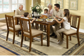 Family gathered around a wooden dining table in a home setting